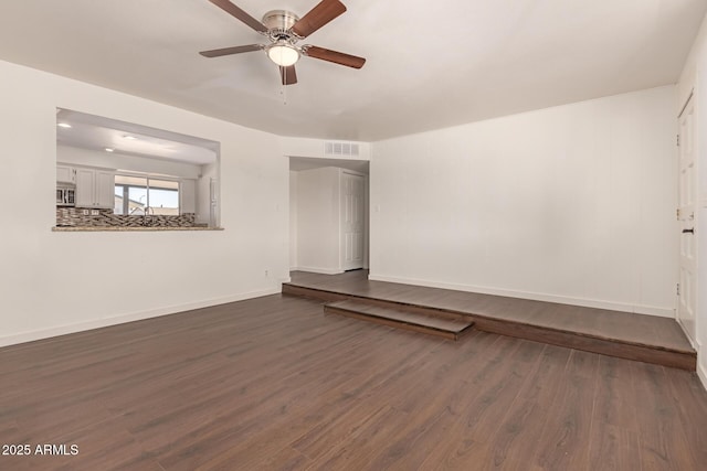 empty room featuring ceiling fan and dark hardwood / wood-style flooring