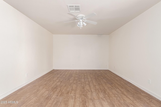 spare room featuring ceiling fan and light hardwood / wood-style floors