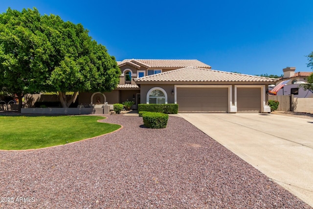 4648 W Misty Willow Ln, Glendale, AZ 85310 - mediterranean / spanish-style home featuring stucco siding, an attached garage, driveway, and a tiled roof