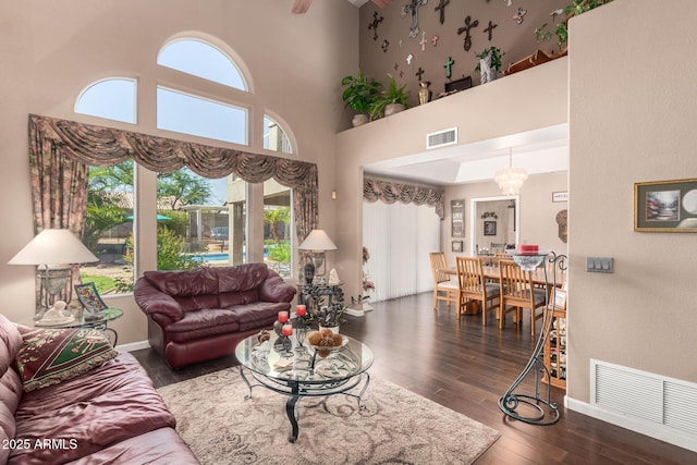 4648 W Misty Willow Ln, Glendale, AZ 85310 - living room with wood-type flooring, a high ceiling, baseboards, and a chandelier