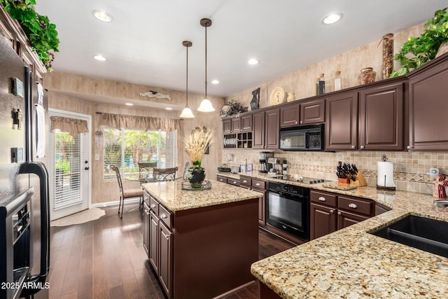 4648 W Misty Willow Ln, Glendale, AZ 85310 - kitchen with black appliances, a center island, dark brown cabinets, backsplash, and recessed lighting