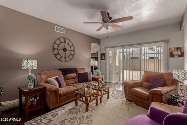 4648 W Misty Willow Ln, Glendale, AZ 85310 - living area featuring ceiling fan, arched walkways, wood finished floors, and a textured ceiling