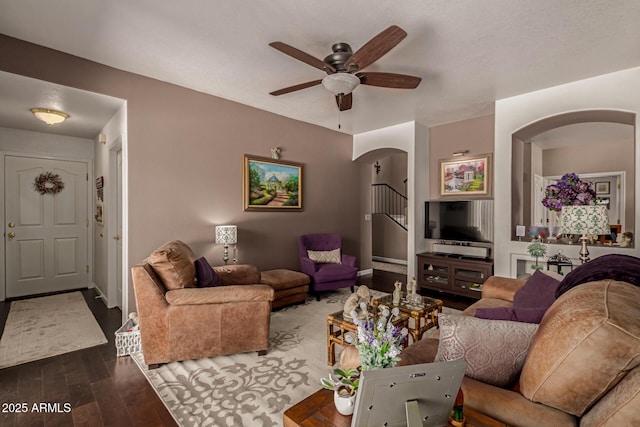 4648 W Misty Willow Ln, Glendale, AZ 85310 - living room with arched walkways, wood finished floors, a ceiling fan, and stairway