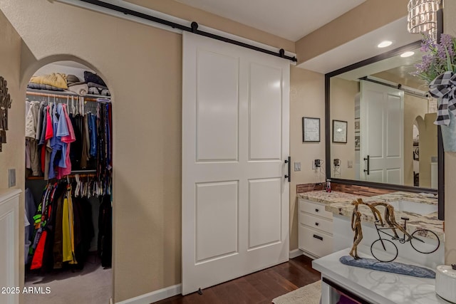 4648 W Misty Willow Ln, Glendale, AZ 85310 - bathroom featuring wood finished floors, a walk in closet, and vanity