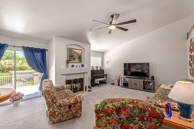 4648 W Misty Willow Ln, Glendale, AZ 85310 - carpeted living area with ceiling fan, vaulted ceiling, and a fireplace with flush hearth