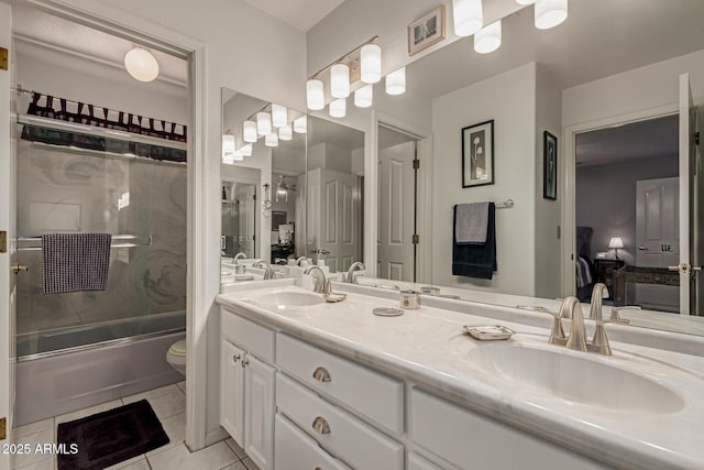 4648 W Misty Willow Ln, Glendale, AZ 85310 - bathroom with double vanity, bath / shower combo with glass door, tile patterned floors, and toilet