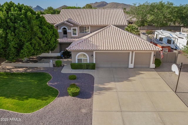 4648 W Misty Willow Ln, Glendale, AZ 85310 - mediterranean / spanish-style house featuring a garage, driveway, stucco siding, and a tile roof