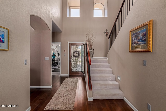 4648 W Misty Willow Ln, Glendale, AZ 85310 - foyer with dark wood-style flooring, stairs, a towering ceiling, baseboards, and a textured wall