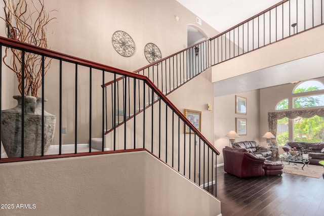 4648 W Misty Willow Ln, Glendale, AZ 85310 - stairs with hardwood / wood-style flooring, a towering ceiling, and baseboards