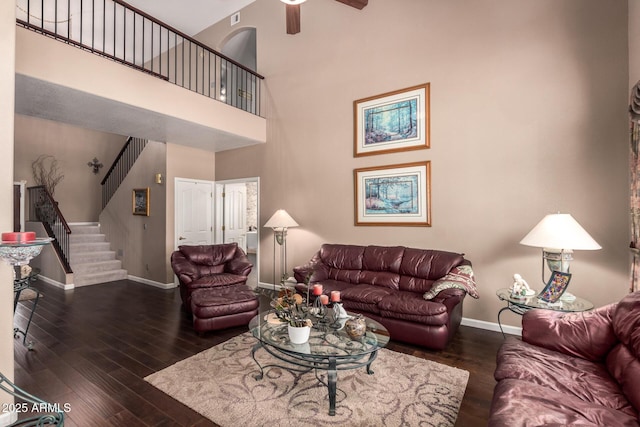 4648 W Misty Willow Ln, Glendale, AZ 85310 - living room with baseboards, hardwood / wood-style floors, ceiling fan, stairway, and a towering ceiling