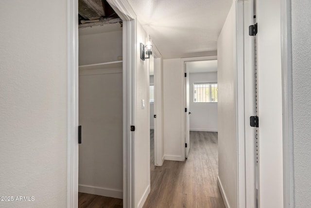 hallway with light hardwood / wood-style floors