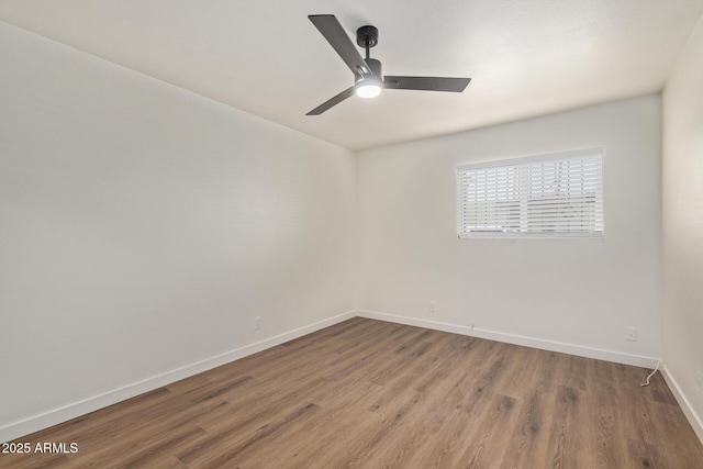 spare room with hardwood / wood-style floors and ceiling fan