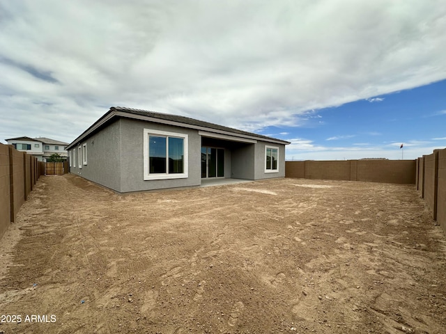 22709 E Saddle Way, Queen Creek, AZ 85142 - rear view of house featuring stucco siding, a fenced backyard, and a tiled roof