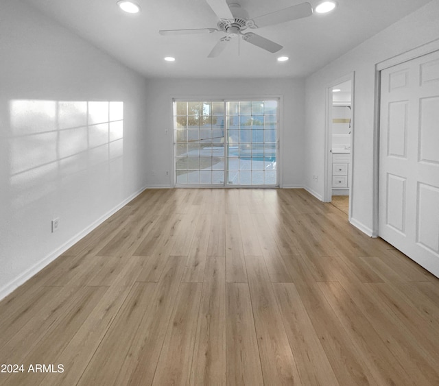 empty room with light hardwood / wood-style flooring and ceiling fan