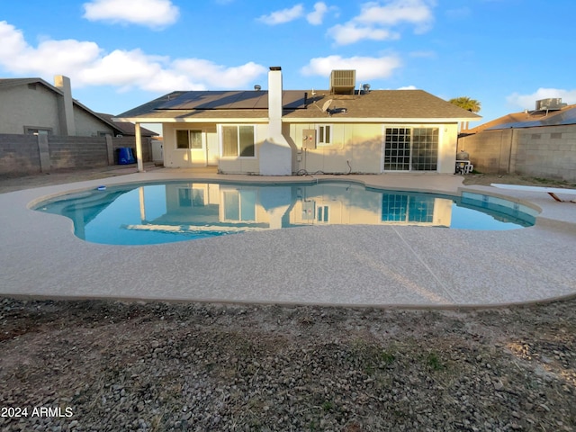 view of swimming pool featuring a diving board and central AC