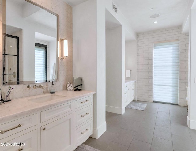 bathroom with tile patterned floors and vanity