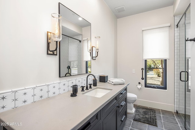 bathroom with tile patterned flooring, vanity, an enclosed shower, and toilet