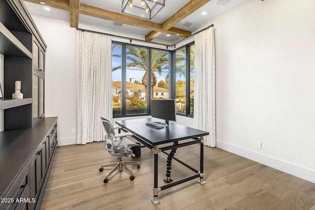 office area featuring floor to ceiling windows, coffered ceiling, beam ceiling, and light wood-type flooring