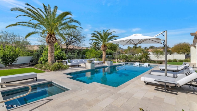 view of swimming pool with a hot tub and a patio area