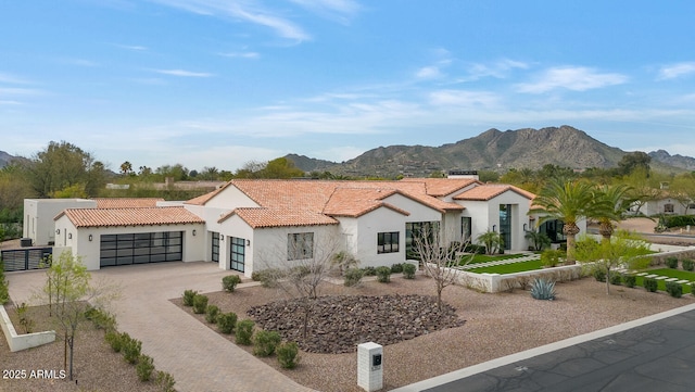 view of front of home featuring a garage and a mountain view