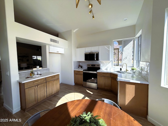 kitchen featuring appliances with stainless steel finishes, sink, and backsplash