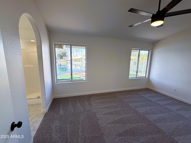 carpeted spare room with ceiling fan