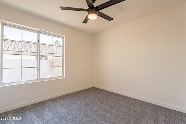 spare room with ceiling fan and carpet