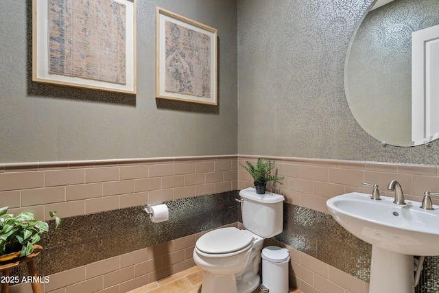 1500 E Sagittarius Pl, Chandler, AZ 85249 - half bathroom with tile walls, toilet, and wainscoting