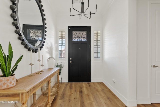1500 E Sagittarius Pl, Chandler, AZ 85249 - entryway featuring a chandelier, wood finished floors, and baseboards