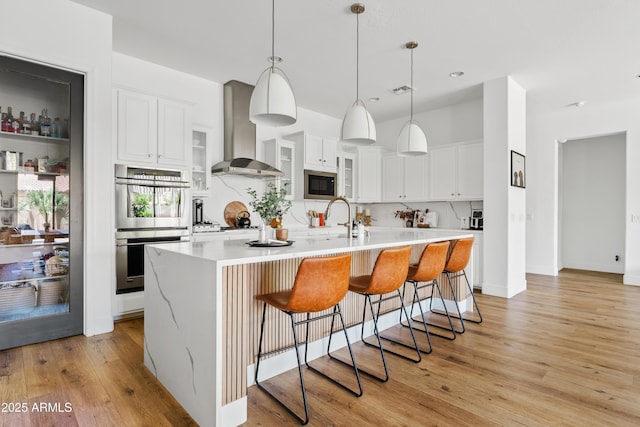 1500 E Sagittarius Pl, Chandler, AZ 85249 - kitchen with stainless steel double oven, wall chimney range hood, tasteful backsplash, built in microwave, and a sink