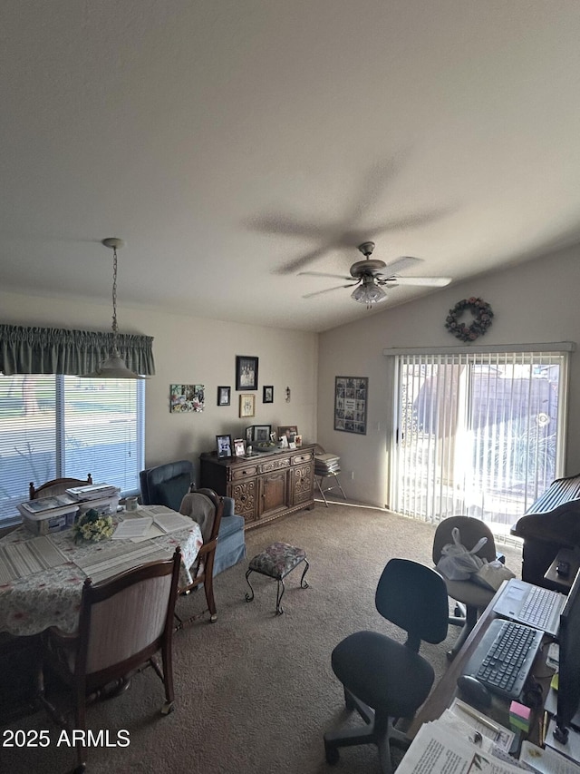 carpeted living room featuring ceiling fan and vaulted ceiling