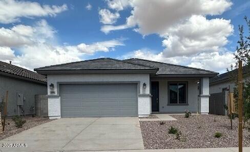 view of front of house with an attached garage, driveway, and stucco siding
