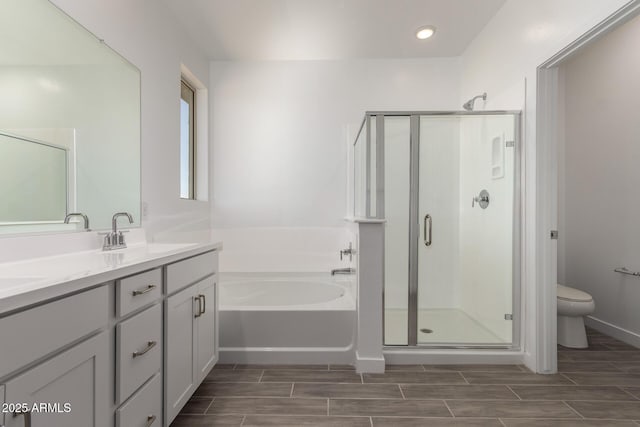 full bathroom with a garden tub, double vanity, a stall shower, wood tiled floors, and recessed lighting
