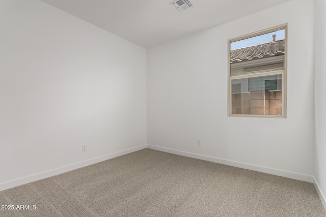 carpeted spare room with baseboards