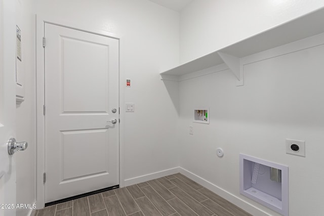 laundry room featuring hookup for a washing machine, baseboards, wood finish floors, electric dryer hookup, and gas dryer hookup