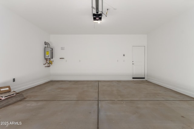 garage featuring water heater, a garage door opener, and baseboards