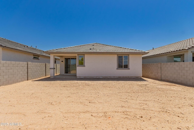back of property with a fenced backyard