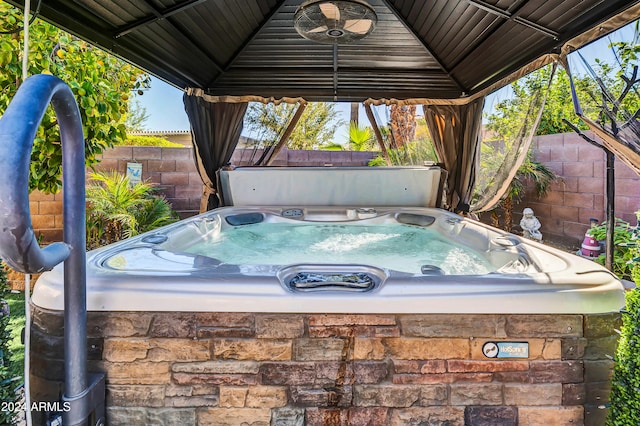 view of patio / terrace featuring a gazebo and a hot tub