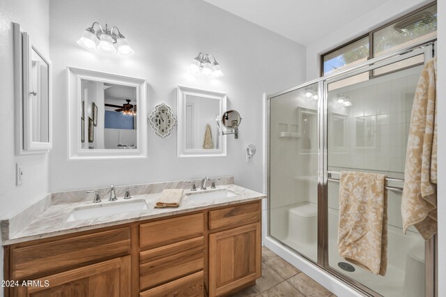 bathroom with tile patterned floors, vanity, and a shower with shower door