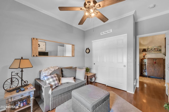 living room featuring crown molding, ceiling fan, and dark wood-type flooring