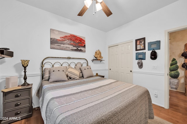 bedroom with hardwood / wood-style flooring, a closet, and ceiling fan