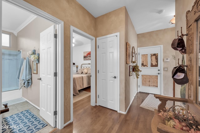 bathroom featuring wood-type flooring and ornamental molding