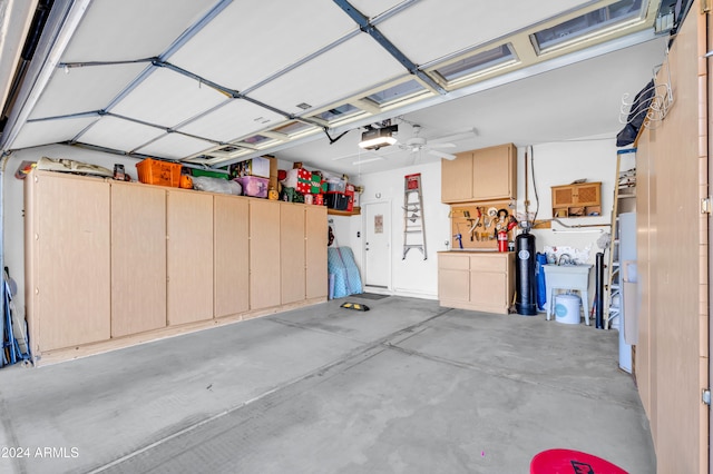 garage featuring ceiling fan and a garage door opener