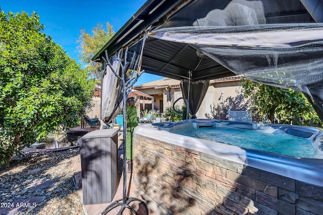 view of swimming pool featuring a hot tub