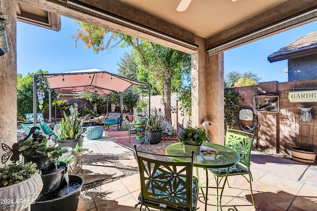 view of patio / terrace featuring a gazebo and ceiling fan