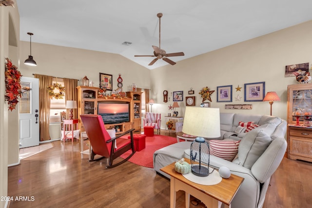 living room with hardwood / wood-style floors, ceiling fan, and lofted ceiling