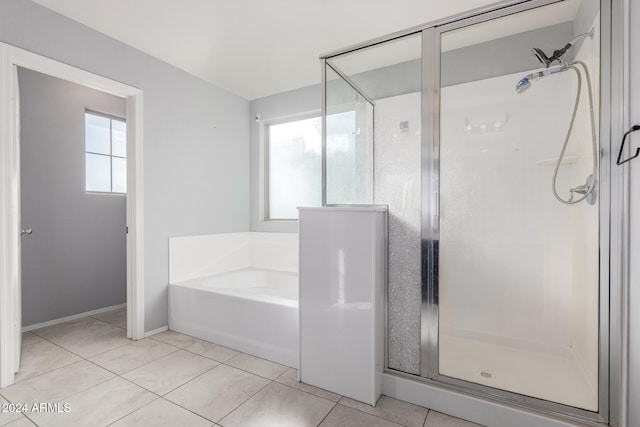 bathroom with tile patterned floors, a healthy amount of sunlight, and shower with separate bathtub