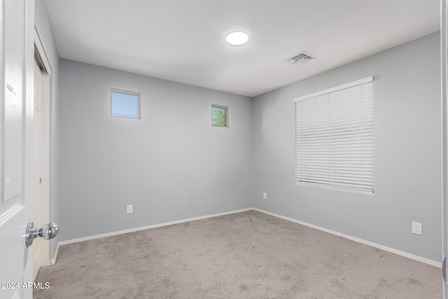 empty room featuring light carpet