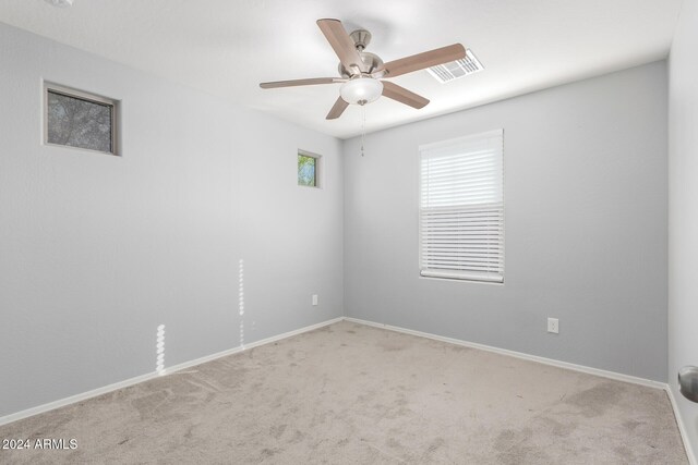 empty room with light colored carpet and ceiling fan