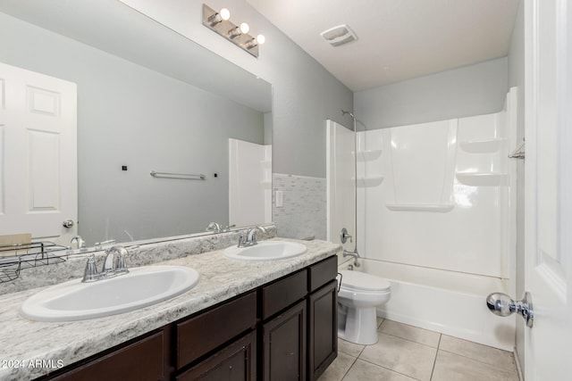 full bathroom with toilet, vanity, tile patterned floors, and tub / shower combination